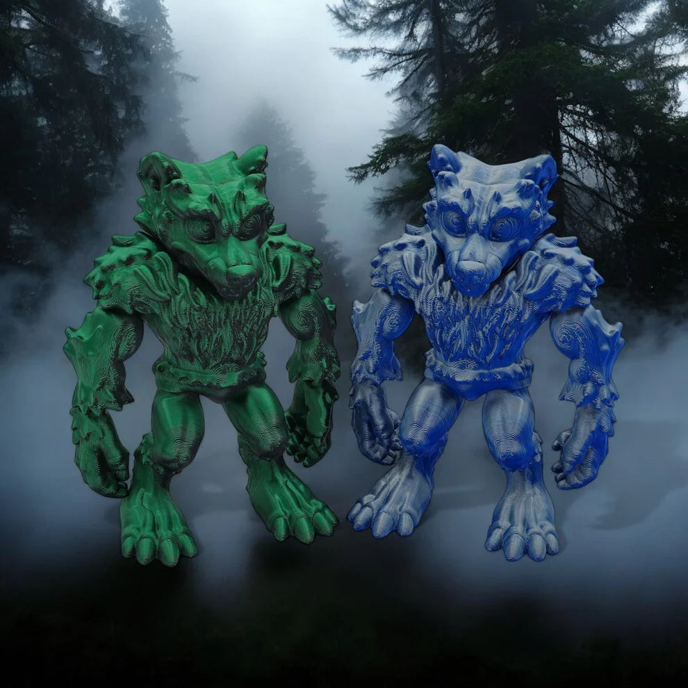 Two monster figurines, one green and one blue, standing in a foggy forest.